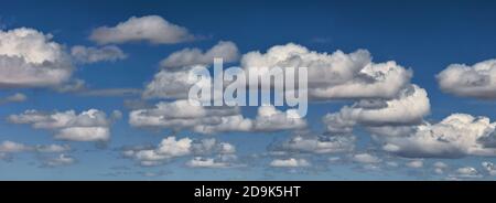 Blue sky with clouds. White fluffy clouds on blue sky in summer. Serenity of the atmosphere. Stock Photo