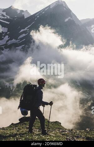 Traveler exploring mountains alone hiking with backpack adventure journey summer vacations traveling lifestyle weekend getaway, concept wanderlust out Stock Photo