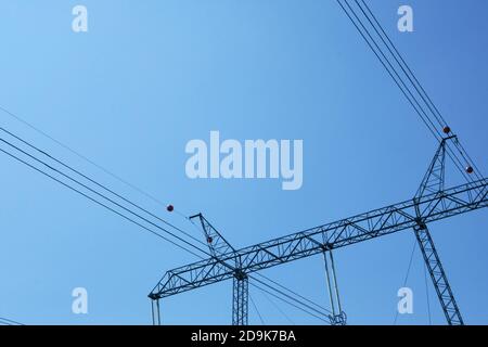 High voltage electrical pole. Electricity pole against blue sky. Transmission line of electricity. Stock Photo