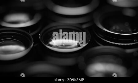 High-aperture camera lenses with reflections, low key image. High-quality photographic lens close photographed. Stock Photo