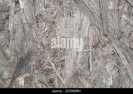 Old destroyed Board. Copy space. Wood texture background. Background of the Bulletin Board. A close-up of a board made of pressed sawdust. Wall surfac Stock Photo