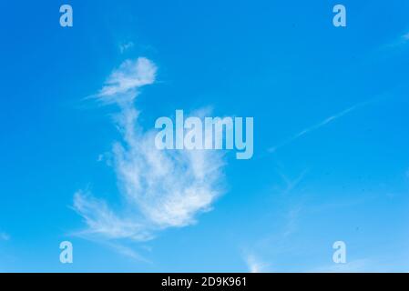 white wispy clouds on a bright clear blue sky Stock Photo