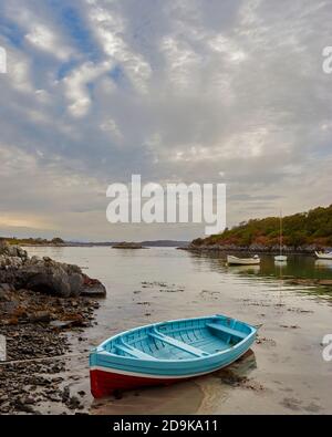 A mackerel sky above a small rowing boat, Glenuig, Moidart, Lochaber, Highland, Scotland Stock Photo