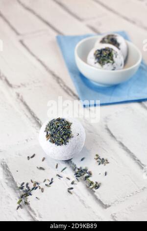 Handmade lavender bath bombs on white brick background Stock Photo
