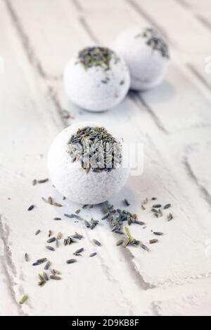 Handmade lavender bath bombs on white brick background Stock Photo