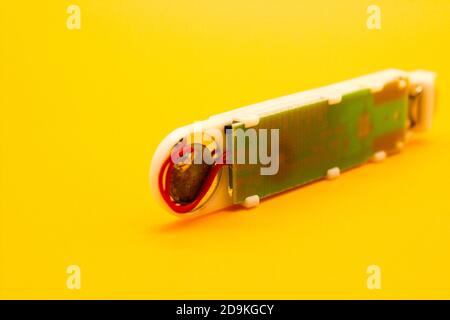 Digital thermometer isolated on yellow background with selective focus Stock Photo