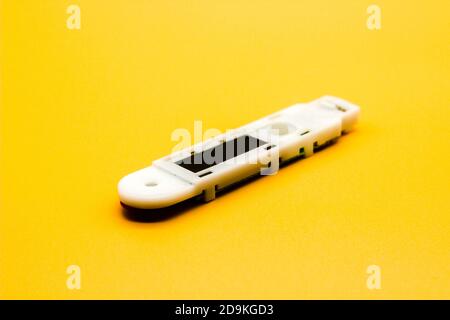 Digital thermometer isolated on yellow background with selective focus Stock Photo