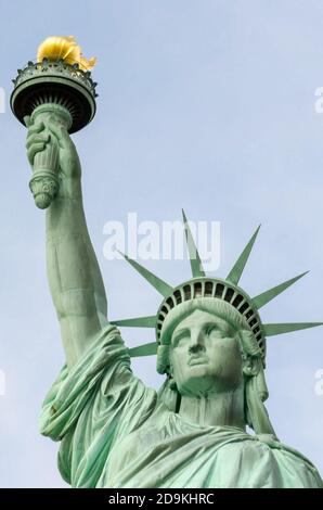 Photo of the Statue of Liberty with her crown holding her torch under a ...