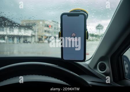 An iPhone X with Waze navigation app inside the car. Waze has gain popularity for its good navigation. Stock Photo