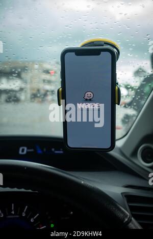 An iPhone X with Waze navigation app inside the car. Waze has gain popularity for its good navigation. Stock Photo