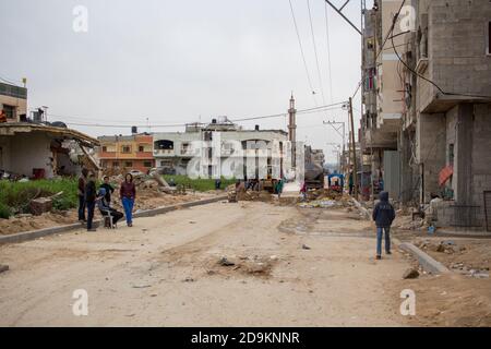 children play near Khan Younis play in the street destroyed by the bombs Stock Photo