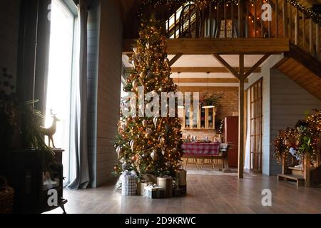 Decorated apartment with festive lights, Christmas tree and gift boxes Stock Photo