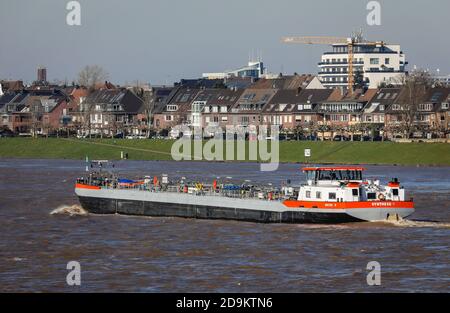 Freighters drive during floods on the Rhine, behind residential houses in the Oberkassel district, Düsseldorf, North Rhine-Westphalia, Germany Stock Photo