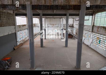 Interior of an abandoned industrial building with columns Stock Photo