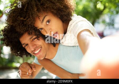 Close up portrait cheerful young african american couple taking selfie Stock Photo