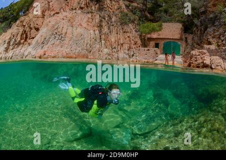 Split level shot of diving on house reef in Tamariu, Costa Brava, Spain, Mediterranean Stock Photo
