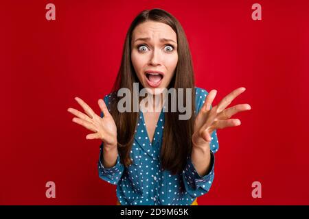 Close-up portrait of attractive desperate puzzled girl bad news panic isolated bright red color background Stock Photo