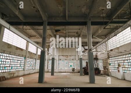 Interior of an abandoned industrial building with columns Stock Photo