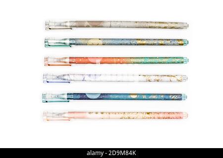 pens in various colors and patterns on a white background Stock Photo