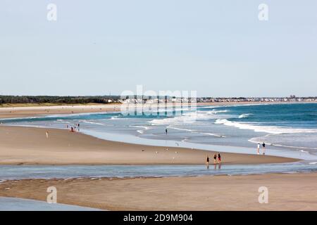 People walking along tidal flats during low tide at Ogunquit Beach in Maine, United States, USA. Stock Photo
