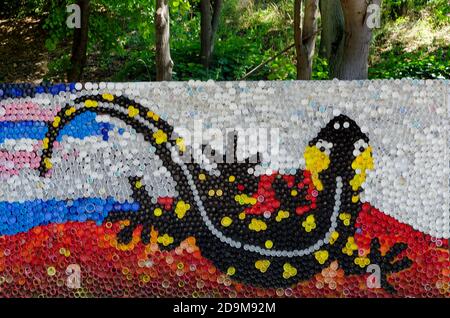 Mosaic with a fire salamander or salamandra  figure made of waste plastic caps, Sofia, Bulgaria Stock Photo