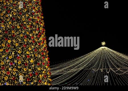 christmas tree with decorates balls and large Christmas decorations in night Stock Photo