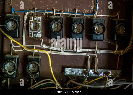 Old ceramic fuse panel in a abandoned building Stock Photo