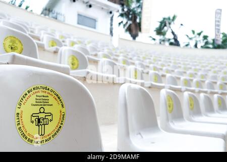 Belek, Turkey - October 2020: Warning sign: leave some seats free for social distancing during coronavirus outbreak. New normal lifestyle in pandemic. Stock Photo