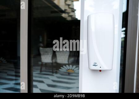 Belek, Turkey - October 2020: Sanitizer device hanging on a hotel territory. Safety measures in all-inclusive hotel to prevent coronavirus spread. Stock Photo