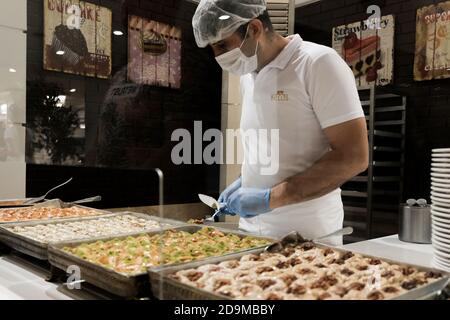 Belek, Turkey - October 2020: Serving food at a restaurant in an all-inclusive resort in Antalya. Healthy safety measures during coronavirus outbreak. Stock Photo