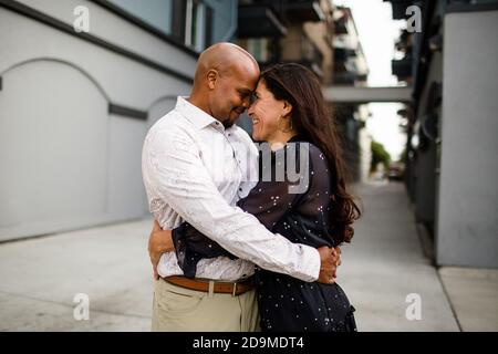 Late Forties Couple Embracing in Alley in San Diego Stock Photo
