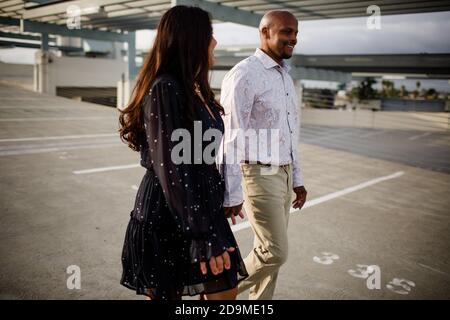 Multiracial Late Forties Couple Walking on Rooftop in San Diego Stock Photo