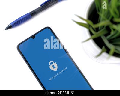 Lod, Israel - July 8, 2020: Modern minimalist office workspace with black mobile smartphone with Microsoft Authenticator app launch screen with logo o Stock Photo