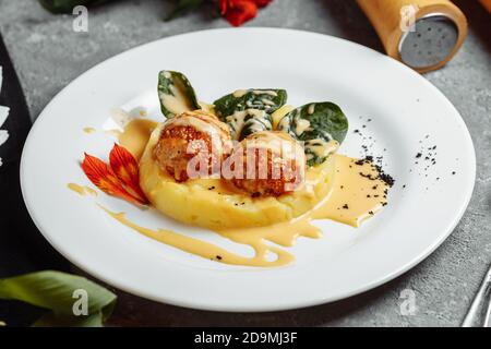 Mashed potatoes with cheese balls in sauce. cheese balls breaded and deep fried. Deep-fried cheese balls Stock Photo