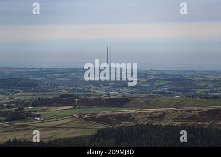 Emley Moor transmitting station under a blanket of clouds from the opt of Holme Moss on a cold breezy day in West Yorkshire Stock Photo