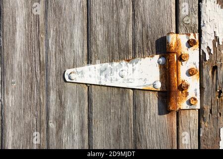 Rusted hinge on old barn door. Stock Photo