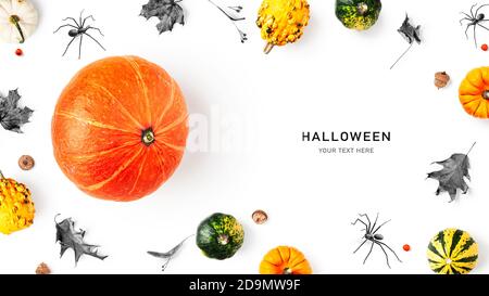 Creative layout with pumpkin, autumn leaves and spiders. Halloween composition on white background. Top view, flat lay. Holiday concept, copy space Stock Photo