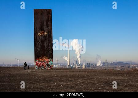 Essen, Ruhr area, North Rhine-Westphalia, Germany, the Schurenbach dump with the sculpture slab for the Ruhr area by Richard Serra, behind the RWE Carnap waste-to-energy plant and the Prosper coking plant in Bottrop. Stock Photo