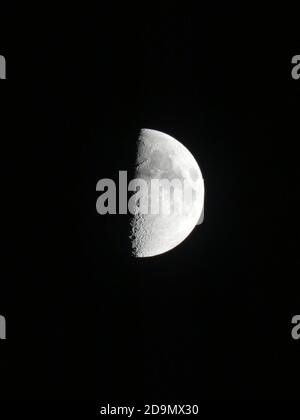 Vertically Split Moon Half moon phase clear black sky Stock Photo - Alamy
