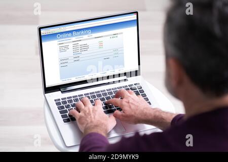 Old Man Using Online Bank To Pay Money Stock Photo