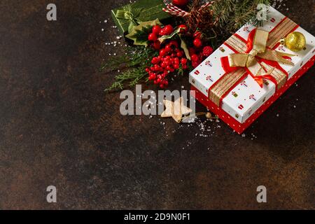 Christmas or New Year concept. Christmas presents gift red box and tree branch decor. Copy space. Stock Photo