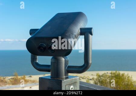Public binoculars in an anti-vandal case. Coin-operated binocular viewer for sea tourists. Stock Photo