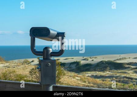Binoculars in an iron case for sea tourists on the shore. Coin-operated binocular viewer. Stock Photo