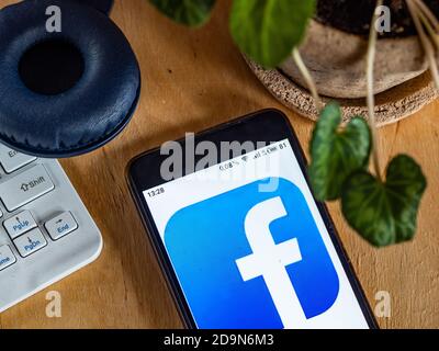 In this photo illustration a Facebook logo is seen displayed on a smartphone Stock Photo