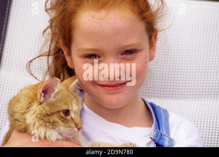 2000s PORTRAIT OF SMILING RED HAIRED FRECKLE-FACED GIRL HOLDING ORANGE DOMESTIC TABBY CAT - kc13025 URS001 HARS FRIENDSHIP HUG CARING PETS FRECKLES ORANGE EYE CONTACT TABBY HAPPINESS MAMMALS ANIMALS CATS HEAD AND SHOULDERS CHEERFUL FELINE REDHEAD WHOLESOME SMILES RED HAIR JOYFUL FELINES PERSONAL ATTACHMENT AFFECTION CREATURE EMOTION KITTY MAMMAL TOGETHERNESS CAUCASIAN ETHNICITY FRECKLE FRECKLE-FACED OLD FASHIONED RED HEAD Stock Photo
