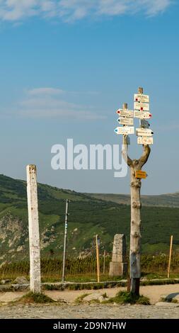 Signs in the mountains showing the direction and length of the route. Stock Photo