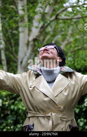 Ayr, Ayrshire, Scotland. Mature white caucasian woman in designer rainwear, enjoying the rain and outdoors Stock Photo