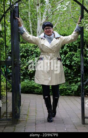 Ayr, Ayrshire, Scotland. Mature white caucasian woman in designer rainwear, enjoying the rain and outdoors Stock Photo