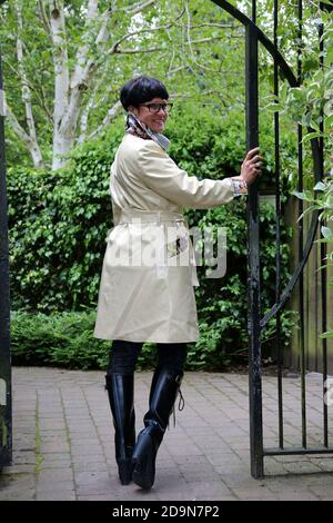 Ayr, Ayrshire, Scotland. Mature white caucasian woman in designer rainwear, enjoying the rain and outdoors Stock Photo