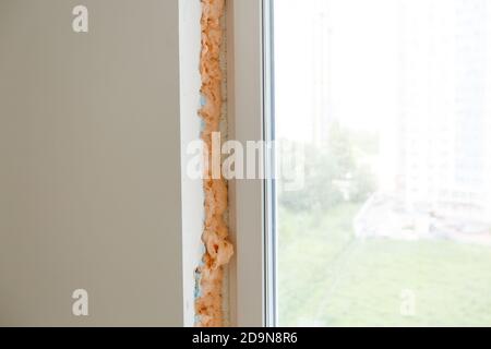 Process installation slopes of window. Using a moanting foam. Stock Photo